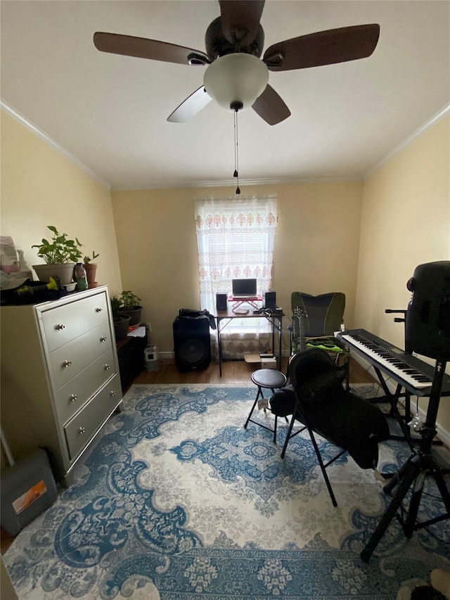 sitting room featuring crown molding, ceiling fan, wood finished floors, and baseboards