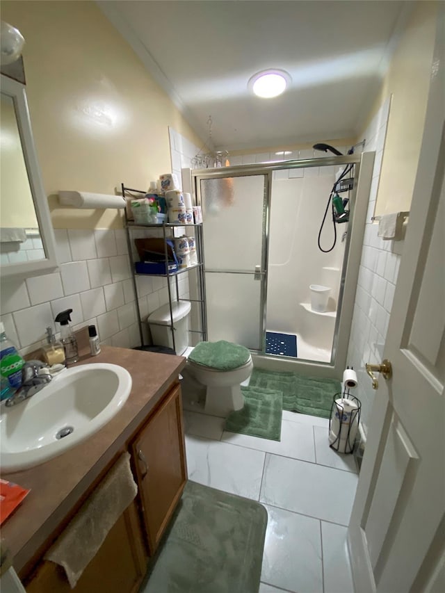 full bathroom with tile walls, a stall shower, vanity, and toilet
