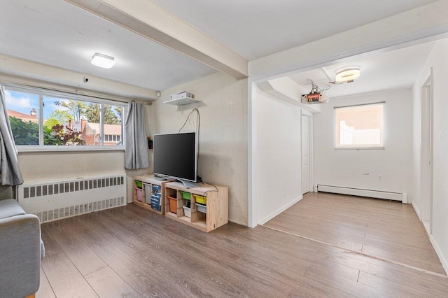 42 Macarthur Ave, Plainview, NY 11803 - living room featuring radiator heating unit, baseboard heating, wood finished floors, and beamed ceiling