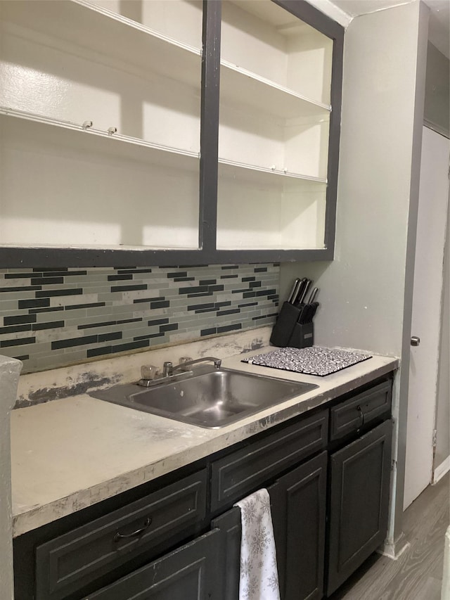 3176 Decatur Ave Unit 4F, Bronx, NY 10467 - kitchen with open shelves, a sink, tasteful backsplash, light wood-type flooring, and dark cabinetry