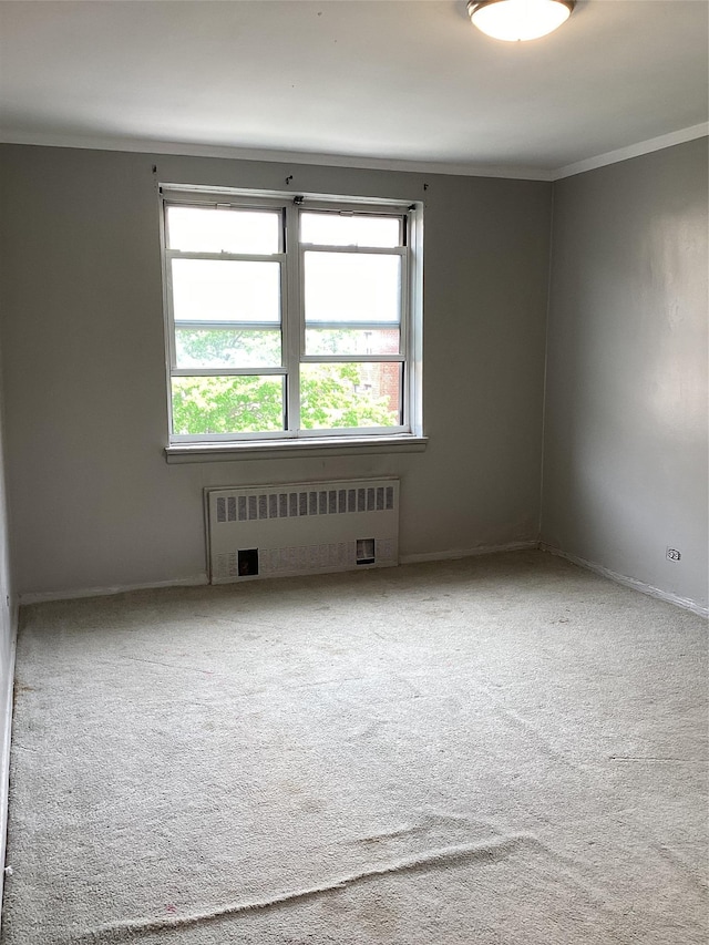 3176 Decatur Ave Unit 4F, Bronx, NY 10467 - unfurnished room with radiator heating unit, crown molding, carpet floors, and baseboards