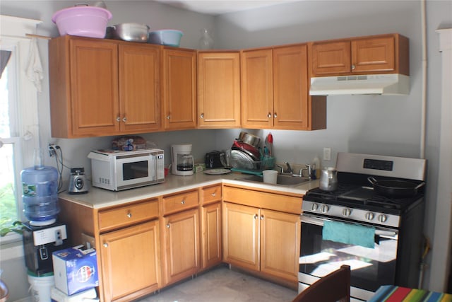 164 Winnikee Ave, Poughkeepsie, NY 12601 - kitchen featuring gas stove, white microwave, under cabinet range hood, light countertops, and a sink