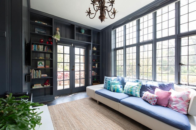 sitting room with french doors and a chandelier