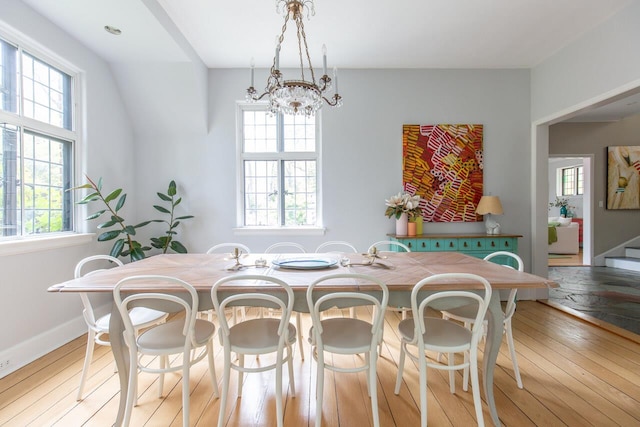 dining space with healthy amount of natural light and light wood-style flooring