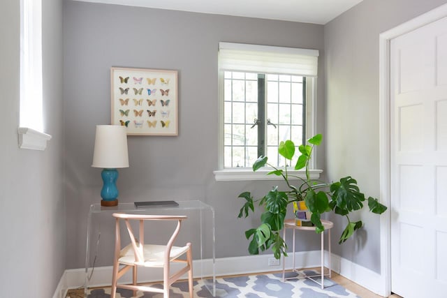 living area featuring baseboards