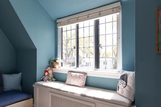sitting room with lofted ceiling