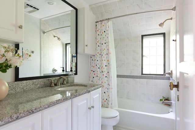 full bathroom featuring toilet, vanity, and shower / bath combo
