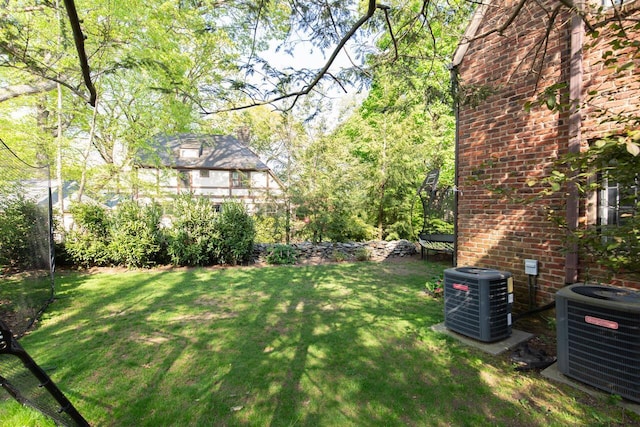 view of green lawn featuring cooling unit