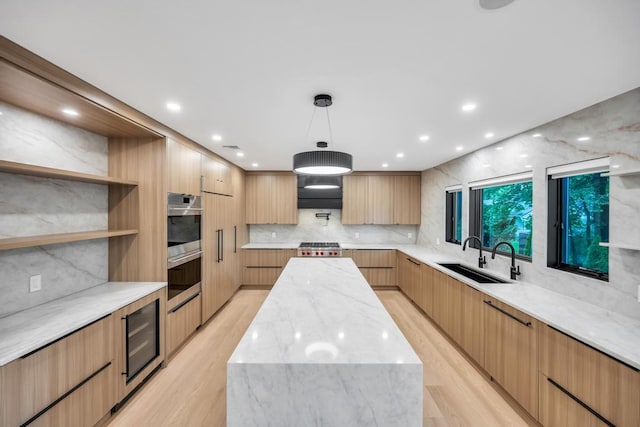 1 Bentley Rd, Great Neck, NY 11023 - kitchen featuring modern cabinets, a sink, a center island, light wood-style floors, and backsplash