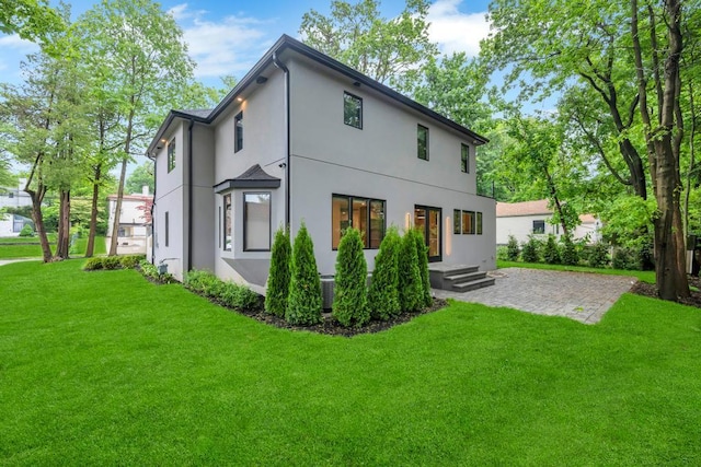 1 Bentley Rd, Great Neck, NY 11023 - back of house featuring stucco siding and a lawn