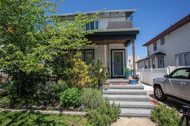 445 W Walnut St, Long Beach, NY 11561 - view of front of property with fence and stucco siding