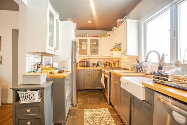 445 W Walnut St, Long Beach, NY 11561 - kitchen featuring appliances with stainless steel finishes, wooden counters, healthy amount of natural light, under cabinet range hood, and recessed lighting