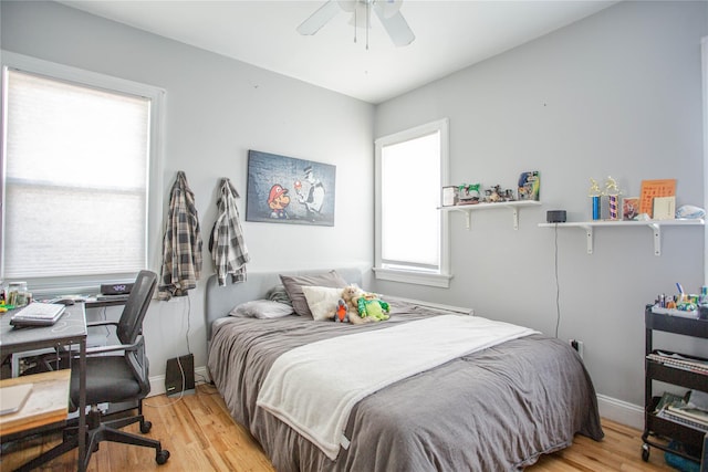 445 W Walnut St, Long Beach, NY 11561 - bedroom with light wood-style flooring, baseboards, a ceiling fan, and a desk