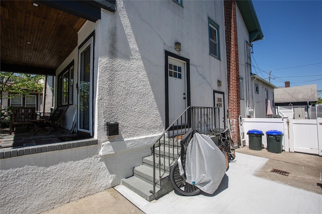 445 W Walnut St, Long Beach, NY 11561 - entrance to property featuring fence and stucco siding