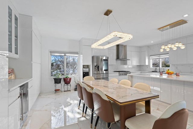 dining room with light marble finish floors and beverage cooler