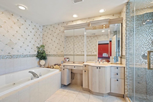 bathroom with tile patterned flooring, a bath, vanity, tile walls, and a shower stall
