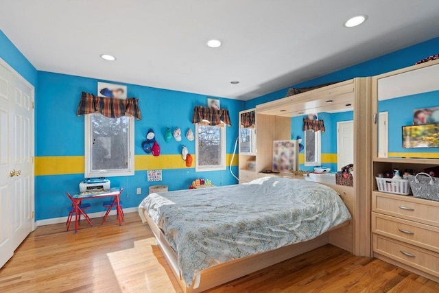 bedroom featuring wood finished floors, recessed lighting, and baseboards