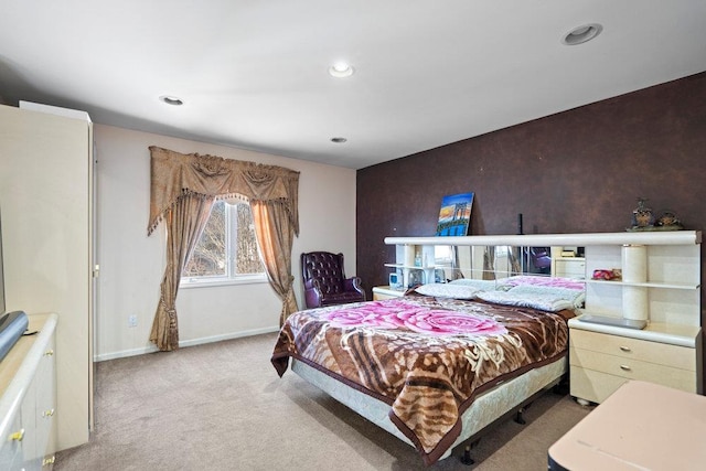 carpeted bedroom featuring baseboards and recessed lighting