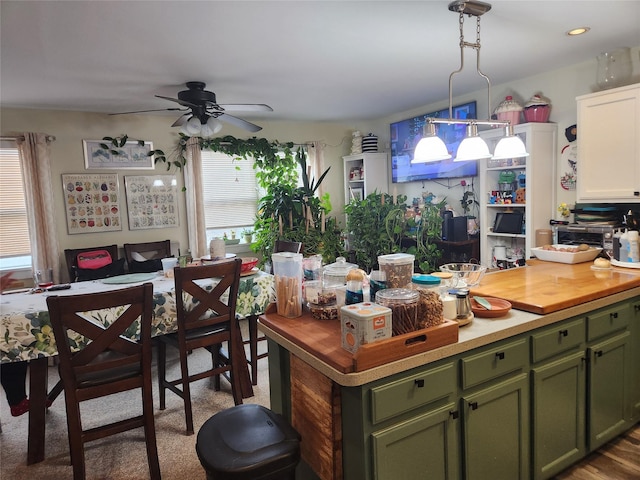 9-16 Bch 98th St, Rockaway Park, NY 11694 - kitchen featuring green cabinets, ceiling fan, wood counters, and decorative light fixtures