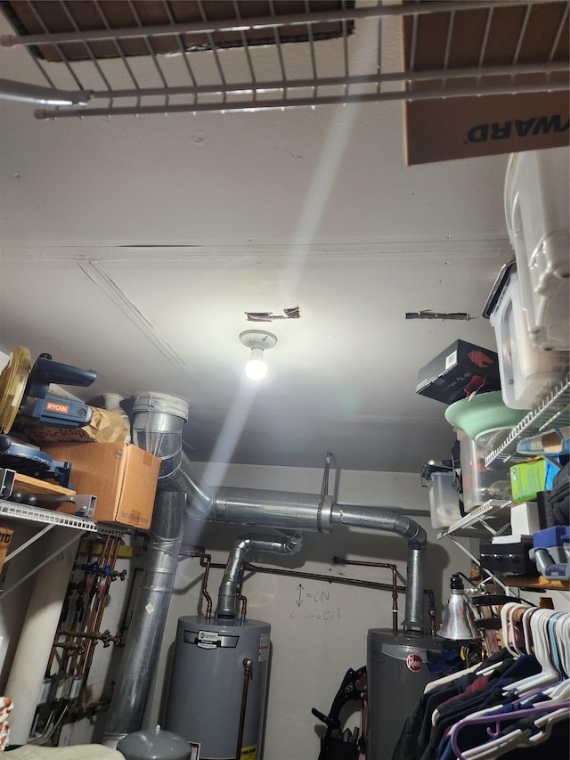 9-16 Bch 98th St, Rockaway Park, NY 11694 - utility room featuring gas water heater and a garage