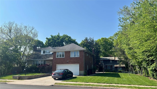 491 Bell St, West Hempstead, NY 11552 - tri-level home with driveway, an attached garage, a chimney, a front yard, and brick siding