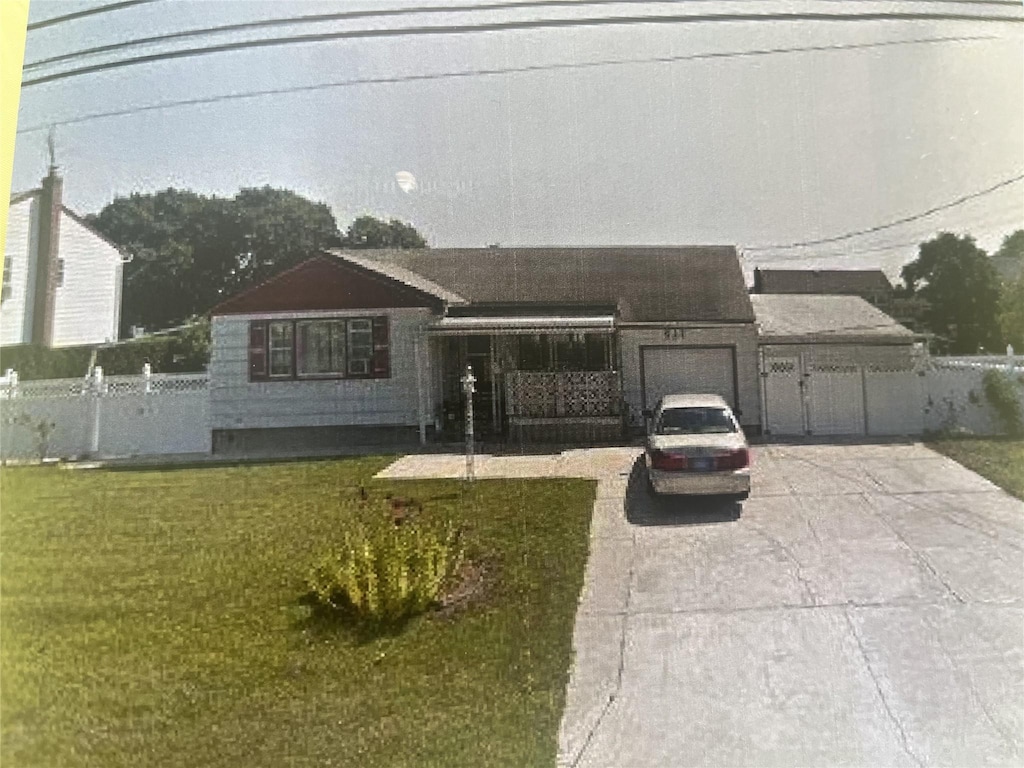 view of front facade with concrete driveway and an attached garage