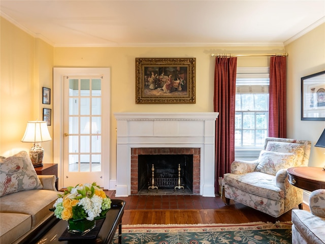 living area featuring dark wood-type flooring, crown molding, and a brick fireplace