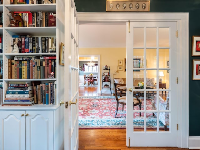 office space featuring wood finished floors, a chandelier, and ornamental molding