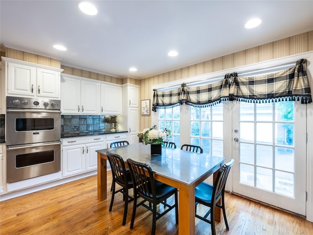 dining area featuring light wood finished floors and recessed lighting