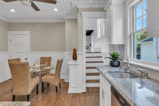 46 Mechanic St, Huntington, NY 11743 - dining room featuring ceiling fan, dark wood-type flooring, an ornate ceiling, a wainscoted wall, and stairs