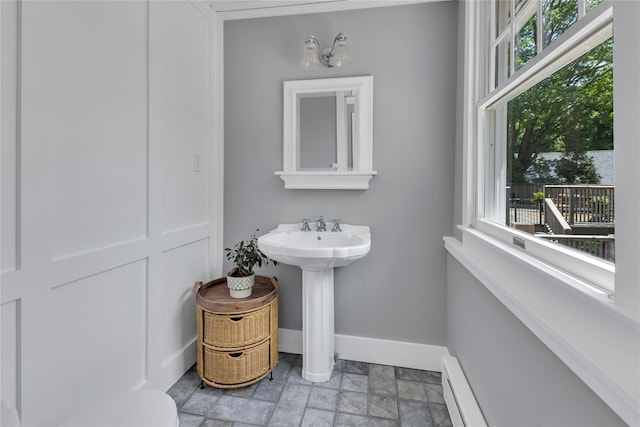 46 Mechanic St, Huntington, NY 11743 - bathroom with baseboards, stone finish floors, and a sink