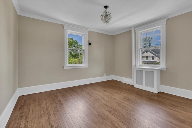 46 Mechanic St, Huntington, NY 11743 - empty room featuring wood-type flooring, healthy amount of natural light, ornamental molding, and baseboards