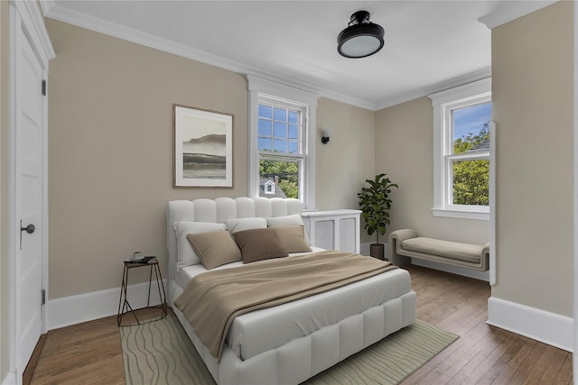46 Mechanic St, Huntington, NY 11743 - bedroom featuring wood finished floors, multiple windows, baseboards, and crown molding