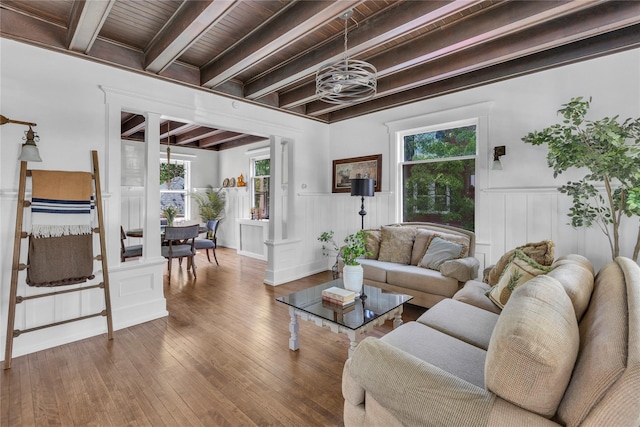 46 Mechanic St, Huntington, NY 11743 - living room featuring a wainscoted wall, hardwood / wood-style floors, wooden ceiling with exposed beams, a decorative wall, and a chandelier