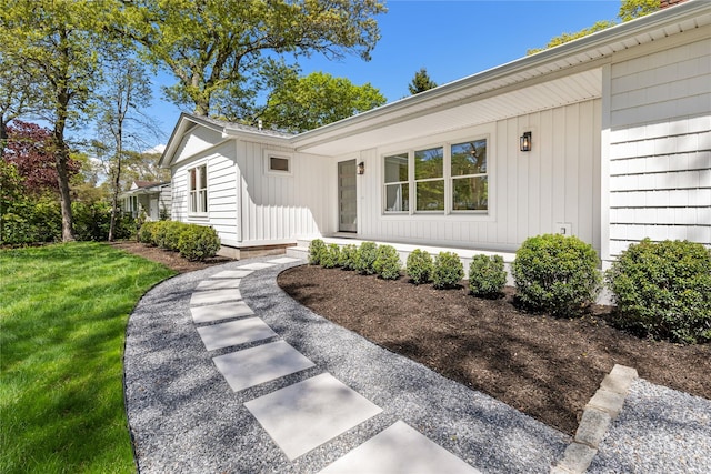 4 Pine Tree Ct, East Quogue, NY 11942 - property entrance with a lawn and covered porch
