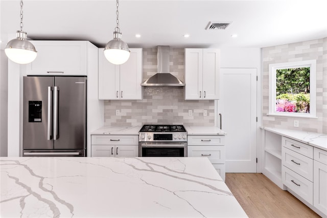 4 Pine Tree Ct, East Quogue, NY 11942 - kitchen featuring stainless steel appliances, wall chimney range hood, light wood-type flooring, white cabinets, and recessed lighting