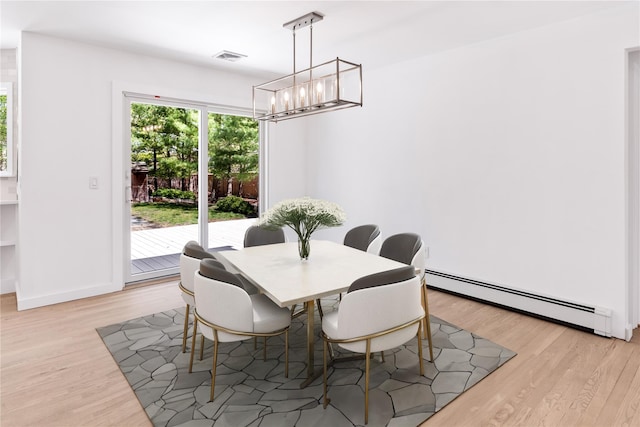 4 Pine Tree Ct, East Quogue, NY 11942 - dining area featuring baseboard heating, a chandelier, light wood finished floors, and baseboards