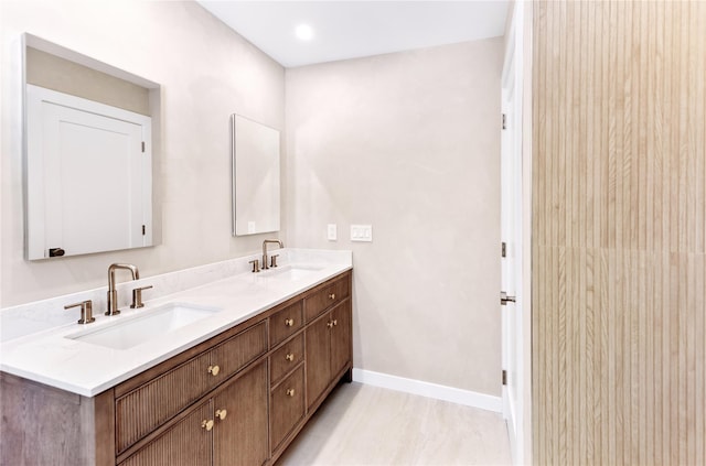 4 Pine Tree Ct, East Quogue, NY 11942 - bathroom with baseboards and double vanity
