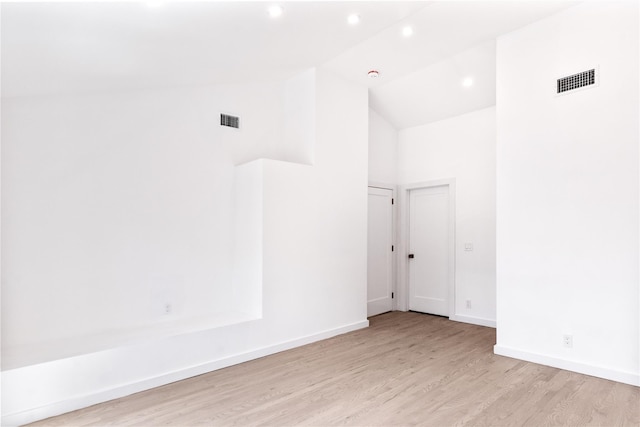 4 Pine Tree Ct, East Quogue, NY 11942 - spare room featuring wood finished floors, high vaulted ceiling, baseboards, and recessed lighting