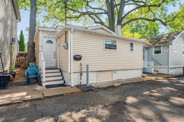 133B Edgewater Park Unit 133B, Bronx, NY 10465 - view of side of property with entry steps, a chimney, and an outbuilding