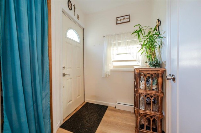 133B Edgewater Park Unit 133B, Bronx, NY 10465 - entrance foyer with baseboard heating, wood finished floors, and baseboards