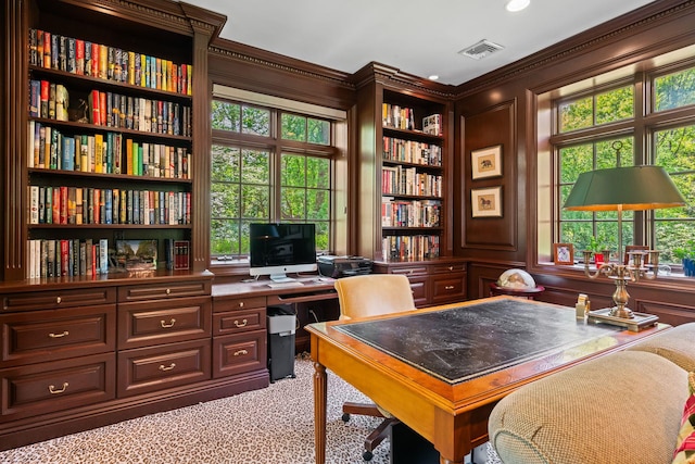 carpeted home office featuring crown molding, healthy amount of natural light, and built in shelves