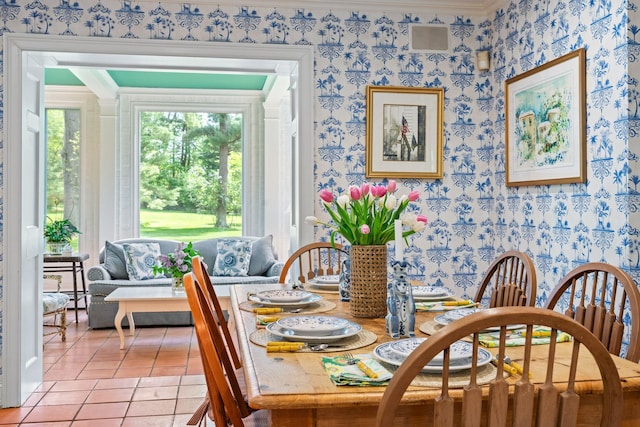 dining room featuring wallpapered walls, crown molding, light tile patterned floors, and baseboard heating