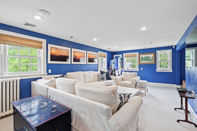 carpeted living area featuring radiator heating unit, recessed lighting, and baseboards