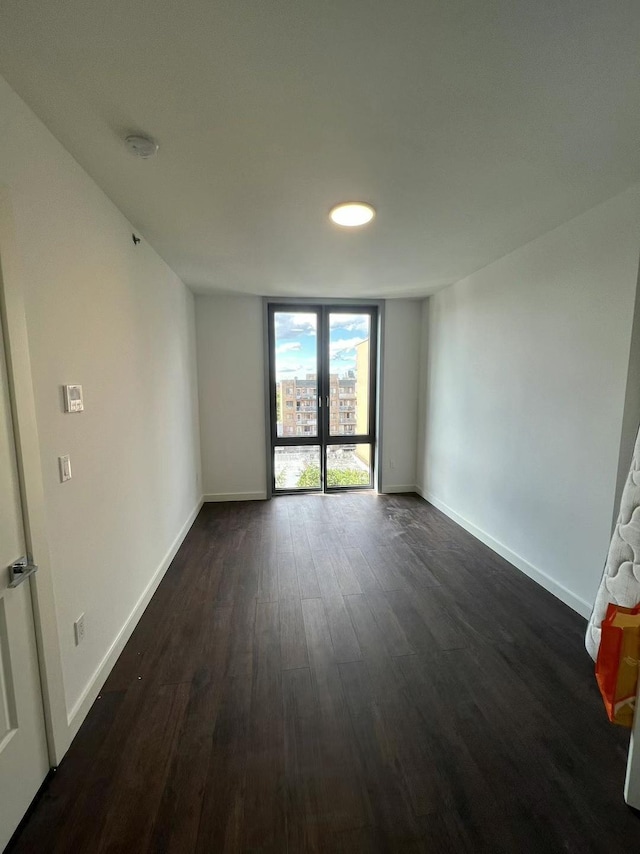144-27 Sanford Ave Unit 6L, Flushing, NY 11355 - spare room with dark wood-style flooring, baseboards, and a smoke detector