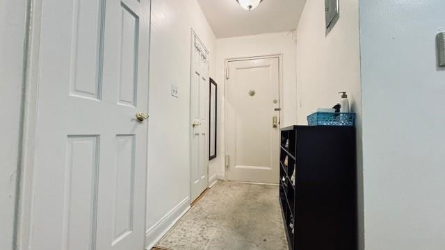 corridor featuring unfinished concrete floors
