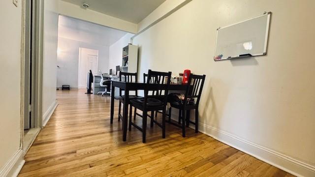 dining area with light wood-style floors and baseboards