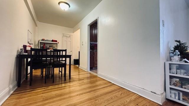 dining area featuring light wood-style flooring and baseboards