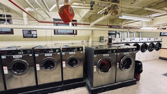 community laundry with washing machine and dryer and tile patterned floors