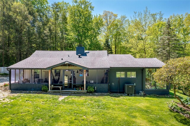 110 Sherwood Hill Rd, Brewster, NY 10509 - rear view of property with a lawn, a chimney, cooling unit, and a shingled roof